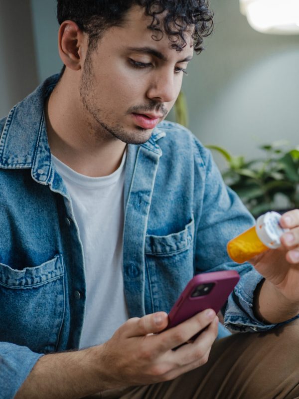 Young man reads about medicine online